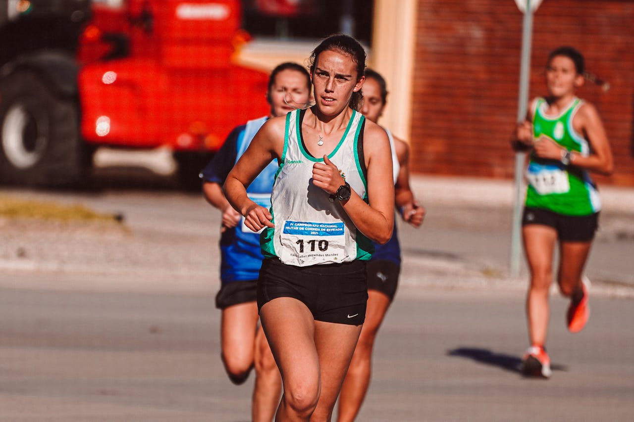 Dynamic shot of female athletes competing in an outdoor urban marathon race.